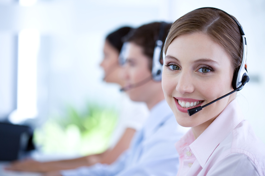 Happy woman wearing a headset working in customer care