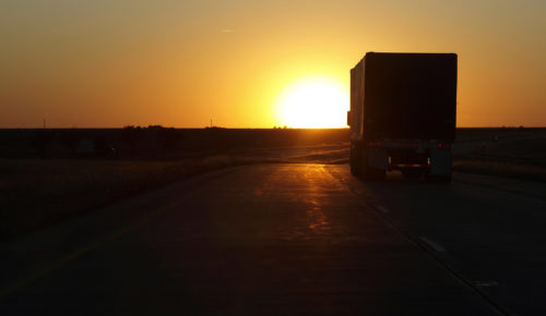 truck driving at sunset, trucking