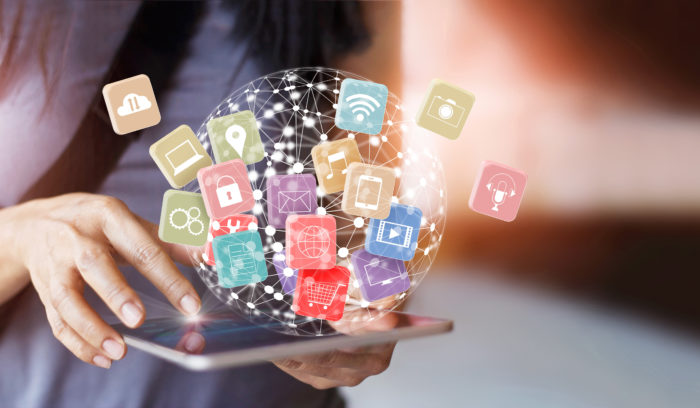 Woman holding tablet with icons global connect customer, retail, omnichannel and multichannel