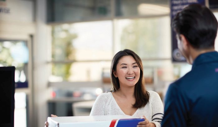 woman opening delivery from provider, brand loyalty