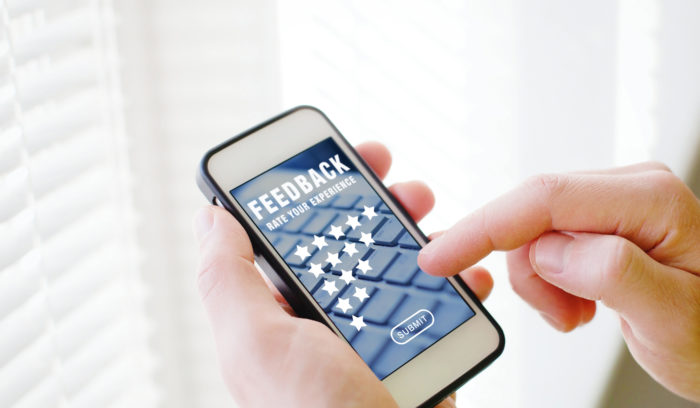 hand holding mobile phone for customer experience