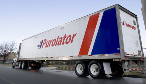 Purolator truck moving industrial equipment