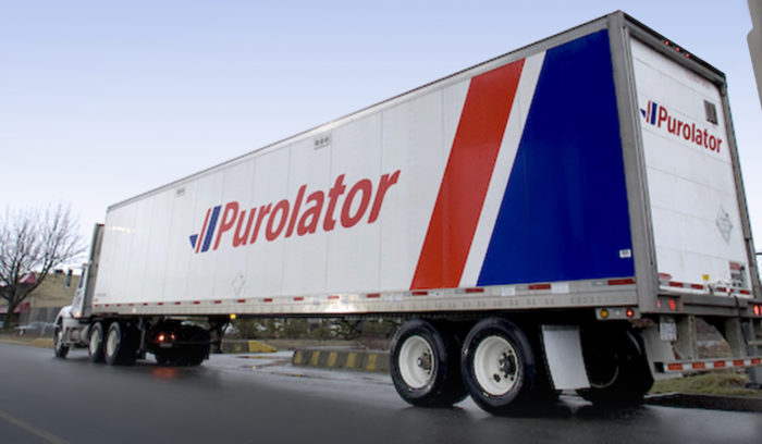 Purolator truck moving industrial equipment