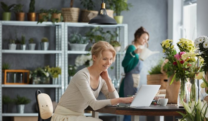 happy woman on computer checking her omnichannel strategy