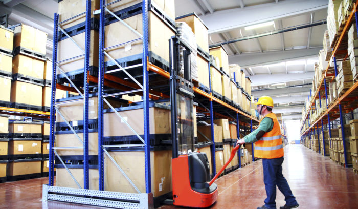 warehouse worker using lift in dark store fulfillment order