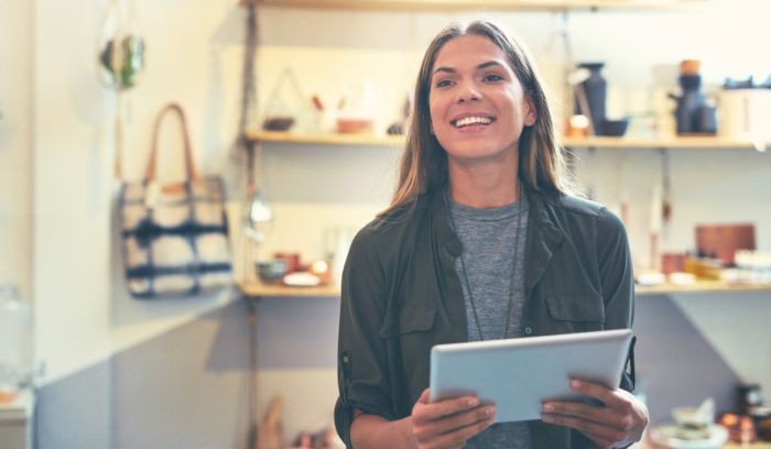 smiling woman with tablet enjoying a personalized customer experience