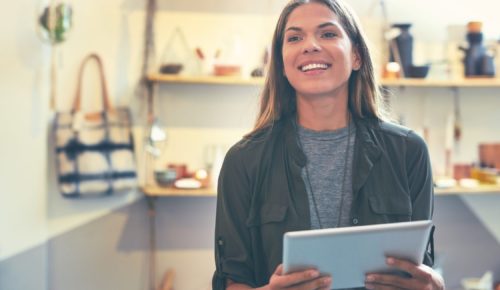 smiling woman with tablet enjoying a personalized customer experience