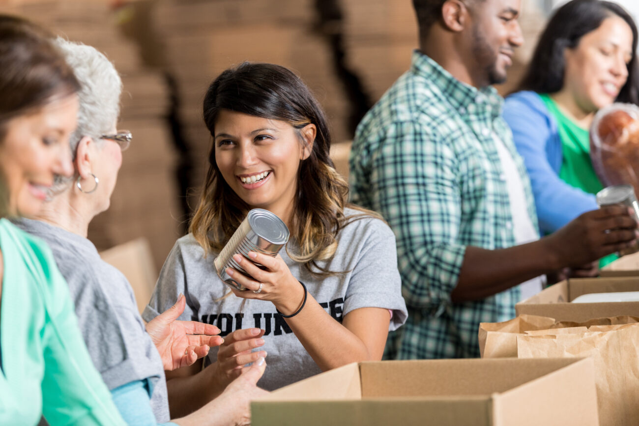 Smiling members sorting food bank boxes