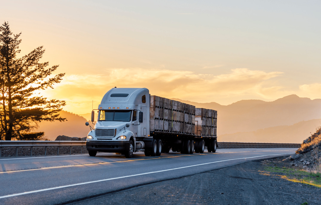transport truck driving during sunset